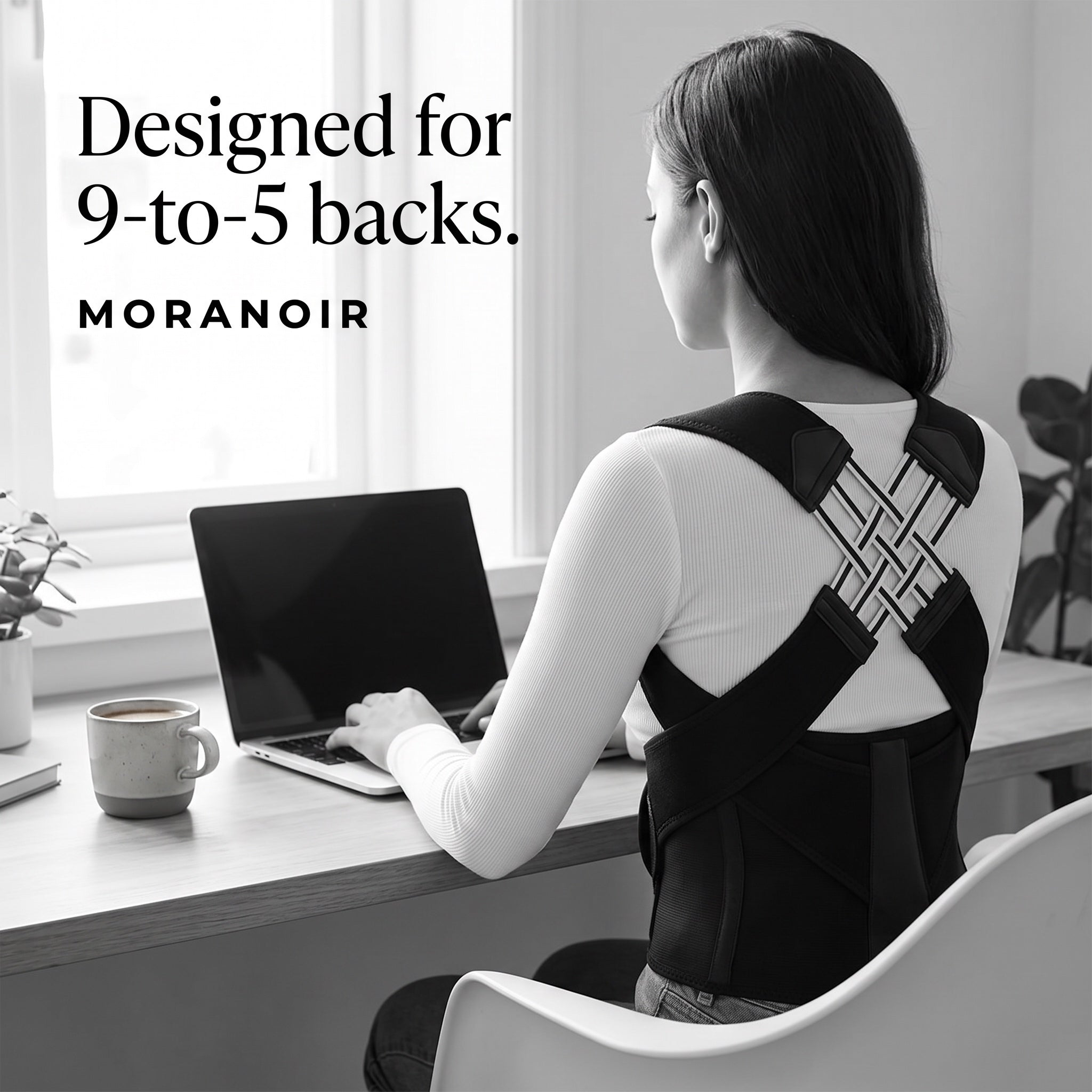Designed for 9-to-5 backs — woman sitting upright at her desk wearing the Moranoir posture corrector.